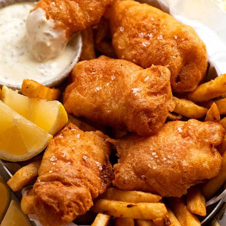 Beer Battered Fish and Chips in a basket with tartare sauce