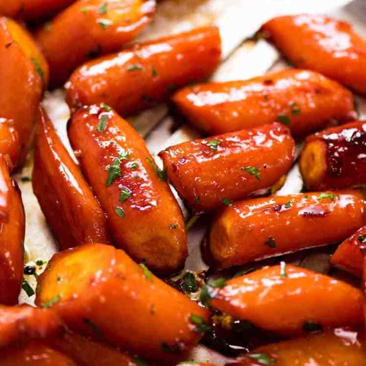 Close up of Brown Sugar Glazed Carrots on a tray, fresh out of the oven
